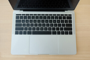Modern laptop on wooden computer desk at workspace in office. Technology Concept