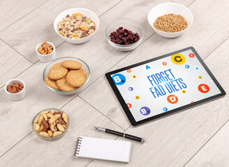 Healthy Tablet Pc compostion with FORGET FAD DIETS inscription, weight loss concept