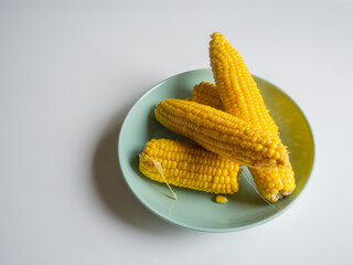 Sweet hot corn on white table