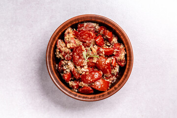Bowl of sun dried tomatoes garlic, oregano, olive oil, top view