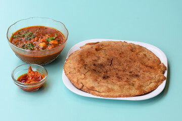 Indian flatbread - Aloo Kulcha with Choley or Stuffed Potato Bread or Stuffed Aloo paratha with tomato ketchup, white chickpeas & pickle - Image