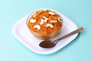Indian traditional sweet,Plain SemolinaSuji Halwa also known as Sweet Rava Sheera OR Shira - Indian festival sweet garnished with dry fruitsServed in a plate or Bowl,Indian dessert