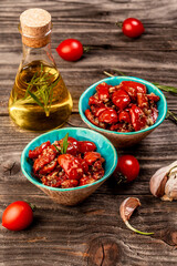 Bowls of sun dried tomatoes garlic, oregano, olive oil, top view