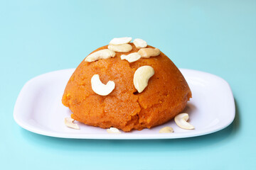 Indian traditional sweet,Plain SemolinaSuji Halwa also known as Sweet Rava Sheera OR Shira - Indian festival sweet garnished with dry fruitsServed in a plate or Bowl,Indian dessert