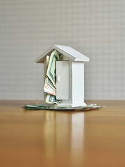 money and house model on the table. concept on the topic of construction and money