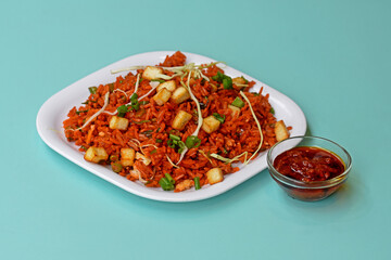 Schezwan paneer fried rice with schezwan sauce,Chinese fried rice with paneer,garnished with spring onion and cabbage