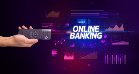 hand holding wireless peripheral with ONLINE BANKING inscription, cyber business concept