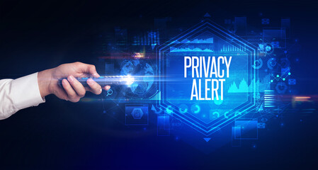 hand holding wireless peripheral with PRIVACY ALERT inscription, cyber security concept