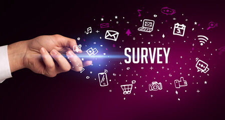 hand holding wireless peripheral with SURVEY inscription, social media concept