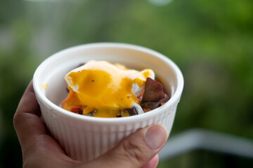 Traditional breakfast. Eggs benedict on a white bowl