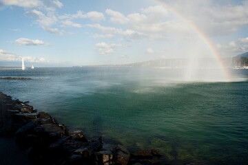 Naklejka na ściany i meble beautiful rainbow on the pier and the water jet in Geneva Switzerland