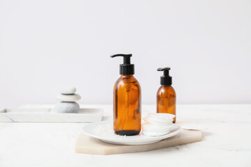 Bottles of different cosmetics on table