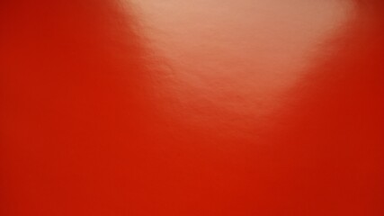 Beautiful bright red background. Closeup sheet of shiny reflecting incident light paper. Pure fun...
