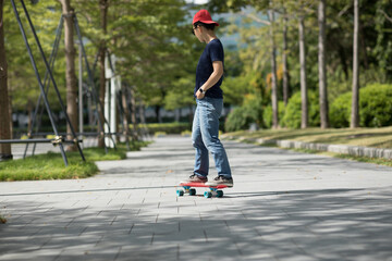 Asian woman skateboarder skateboarding in modern city