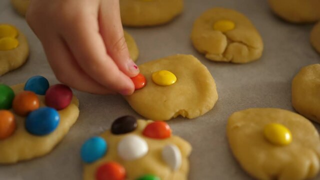 children's hands take colorful dragees candies chocolate