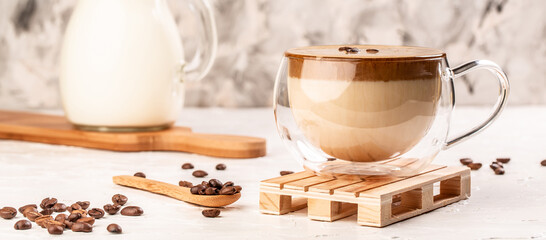 trendy fluffy creamy whipped coffee, Iced Dalgona Coffee on a light background, Long banner format