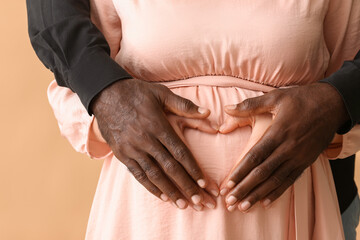 Caucasian pregnant woman and her African-American husband, closeup. Racism concept
