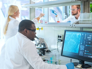 Scientist and students working in lab. Doctor teaching interns to make blood analyzing research. Coronavirus, chemistry, bacteriology, virology and health care