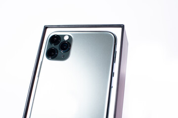 Green smartphone with three cameras on a white background