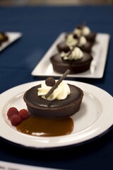 Chocolate Ganache Tart with Whipped Cream, Chocolate Stick, raspberies, chocolate sauce