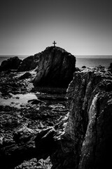 Latin cross or crux immissa or christian cross on the top of a rock, in the middle of the sea - Tabarca Island, Alicante, Valencia, Spain