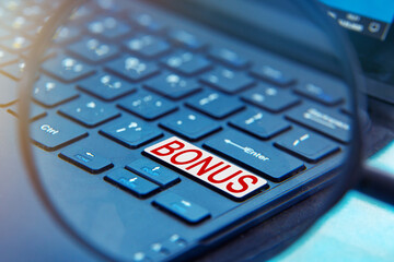 A laptop computer with a magnifying glass.