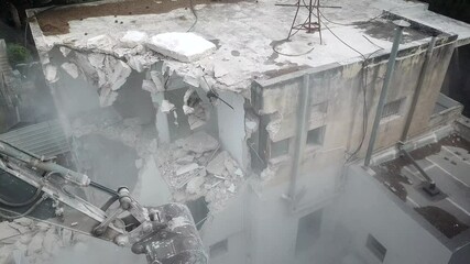  Urban Regeneration. Demolition of a building for new construction. Dismantling of a house. Excavator demolishing barracks for new construction project. Urban Renewal‎.