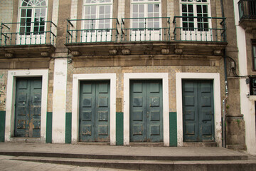 Old and vintage facade of residential building with blue doors and white windows and typical Portuguese tile walls in the center of Porto Portugal Europe