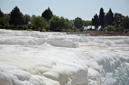 White travertine teras with a green forest in the background
