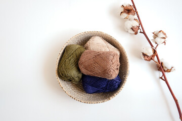 Yarn balls in the basket on white background