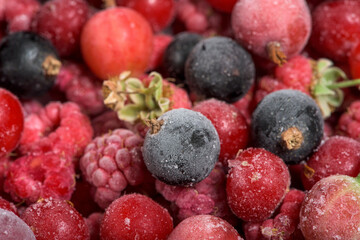 frozen fruit cherry, raspberry, blackcurrant in bags, close-up view from above