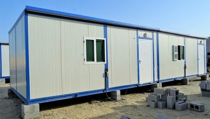 Obraz na płótnie Canvas Portacabin, porta cabin, temporary labours camp , Mobile building in industrial site or office container Portable house and office cabins. Labor Camp. Porta cabin. small temporary houses