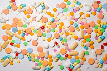 Colorful drugs, vitamins and medicine - capsules, tablets, pills - against white background