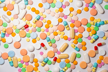 Colorful drugs, vitamins and medicine - capsules, tablets, pills - against white background