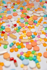 Colorful drugs, vitamins and medicine - capsules, tablets, pills - against white background
