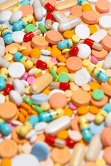 Colorful drugs, vitamins and medicine - capsules, tablets, pills - against white background