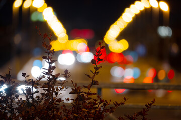 Night city in the evening with headlights blurry of cars and street lamps