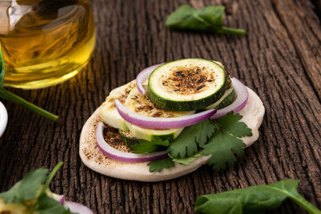 grill naan with zucchini on wood