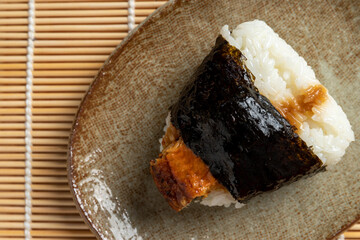 Japanese sushi foods, rice balls and eel unagi on top bind by seaweeds