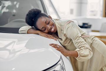 attractive afro woman dreams about new car, young female came to see automobiles, make purchase....