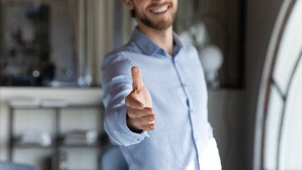 Crop close up of male employer stretch hand for handshake, get acquainted greeting with newcomer in...