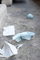 used surgical mask on the floor. discarded mask concept corona virus,covid-19.