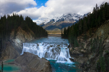 Fototapeta premium Yoho National Park depicting nature photography with Rocky Mountains and snowy peaks and wapta falls - geometrical concept between hills.