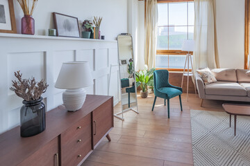 Vintage studio apartment interior in light colors in old style. huge room with large windows with a living room area and a bedroom area. direct sunlight inside.