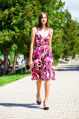 Young beautiful brunette woman in summer dress