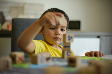 young child playing with cubes