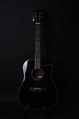 Black acoustic guitar studio shot on black background with copyspace, Guitar is favorite music...