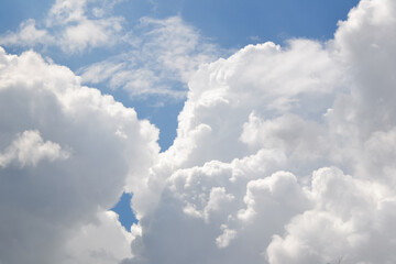 Clouds background. Blue sky with fluffy white clouds. Sunny day with beautiful weather.