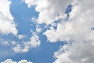 Naklejka na ściany i meble Clouds background. Blue sky with fluffy white clouds. Sunny day with beautiful weather.