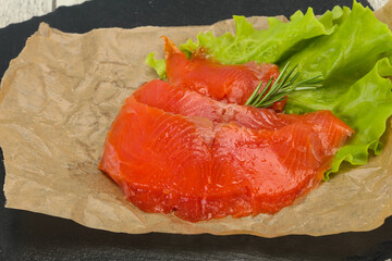 Sliced salmon fillet served rosemary